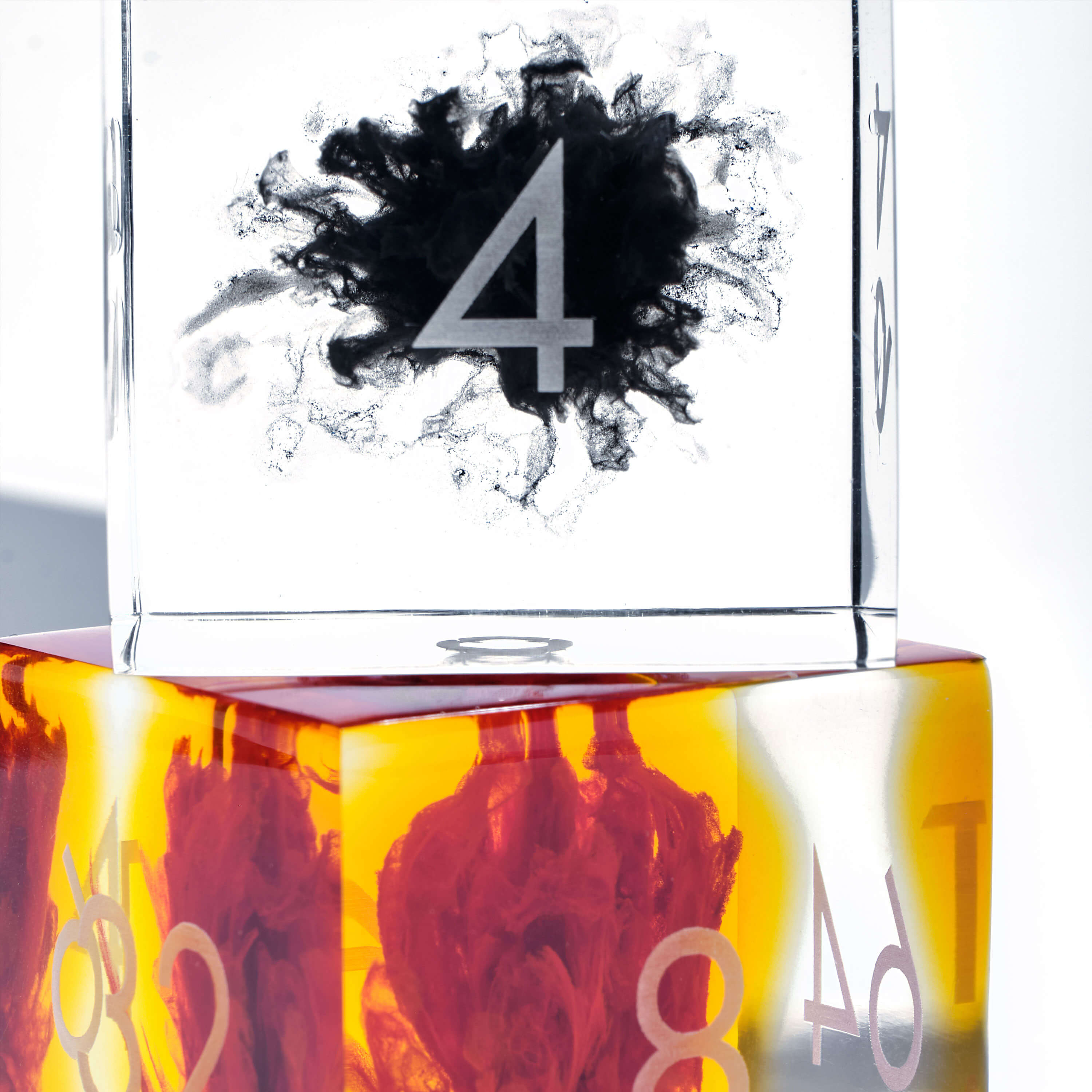 Black and orange pigment bursts in clear resin doubling cubes